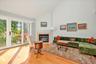 Living room has a fireplace with mantle and SGD to Deck