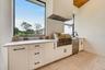 Summer kitchen complete with grill, hood, beverage refrigerator, sink and UV-stabilized High Density Polyethylene (HDPE) cabinetry