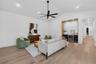 Game room features a wet bar with beverage refrigerator and two large sliding glass doors that provide direct access to pool and covered lanai