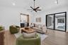 Game room features a wet bar with beverage refrigerator and two large sliding glass doors that provide direct access to pool and covered lanai