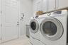 Laundry room with utility sink and cabinets