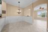 A charming spot for casual meals, framed by classic wainscoting and arched openings.