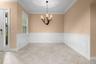 Classic wainscoting and crown molding create a lovely setting for dinners with family and friends.