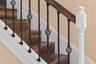 Rich wood tones and decorative ironwork add character to the staircase.