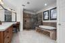 A spacious retreat with a soaking tub, glass-enclosed shower, and plenty of room to get ready.