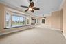 A spacious, light-filled retreat with expansive windows, a built-in window seat, and beautiful views.