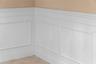 Detailed wainscoting adds timeless charm to the home’s gathering spaces.