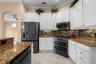 A gas range, decorative backsplash, and under-cabinet lighting bring style and function to meal prep.