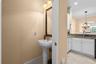A conveniently located half bath just off the kitchen makes hosting guests easy.