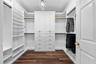 Keep everything organized with custom drawers, shelving, and generous hanging space in the walk-in closet.