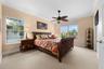 A bright, welcoming bedroom with plenty of natural light and room for overnight guests.