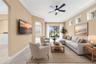 High ceilings and natural light create an inviting space to relax, with golf course views just beyond the sliders.