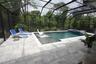 SUN SHELF POOL WITH PAVED DECK AND SCREEN ENCLOSURE