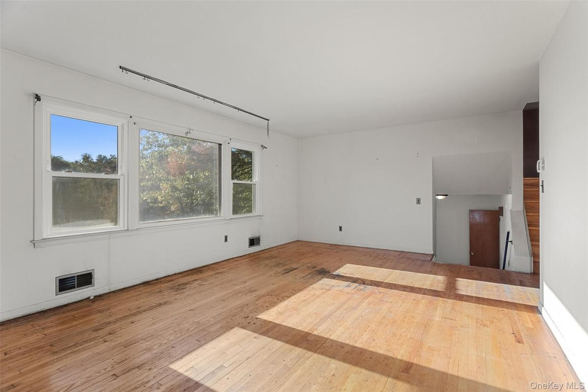 Natural light and hardwood floors provide a wonderful foundation for a beautifully reimagined living space.