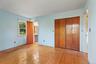 Hardwood floors and natural light provide a welcoming foundation for a comfortable bedroom retreat.