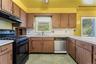 Multiple windows bring natural light into the kitchen and offer views of the surrounding property.