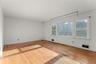 Classic proportions and hardwood floors offer a versatile canvas for creating a sophisticated living room.