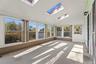 Walls of windows bring the outdoors in and showcase the light and possibilities of this inviting space.