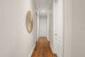 Downstairs Primary has 2 walk in closets on the right, 1 full size clothes closet on the left and an additional linen closet on the left, leading to t