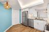 Kitchen remodel includes pantry closet and extra pantry next to the refrigerator.