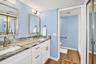 Primary Bathroom, newly updated with double sink shaker cabinet vanity with soft close drawers, lighting, mirrors and paint.