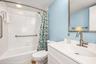 Guest bathroom with updates - Vanity, lighting, mirror, toilet and flooring