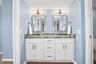 Primary Bathroom, newly updated with double sink shaker cabinet vanity with soft close drawers, lighting, mirrors and paint.