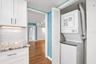 Notice pretty glass subway tiles and Washer Dryer conveniently located in the unit