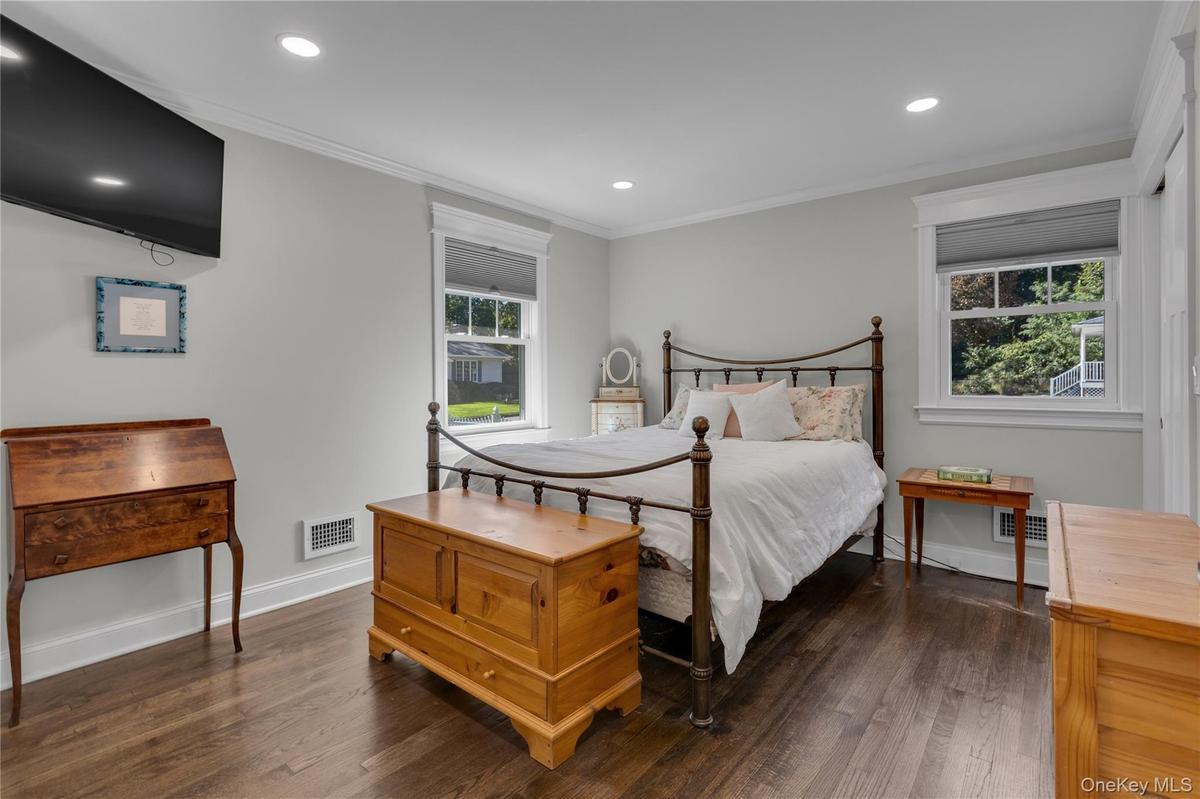 Wood-finish flooring, recessed lighting, and crown molding