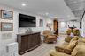 Recessed lighting, wood-finish flooring, white walls, built-in shelving, and a white paneled door