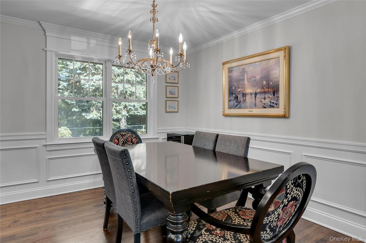Hardwood flooring, decorative wainscoting, crown molding, double window,