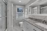 Dual vanity with granite countertops, undermount sinks, and brushed nickel fixtures