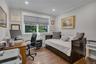 Hardwood-style flooring, white crown molding, recessed lighting, and a large window with white trim