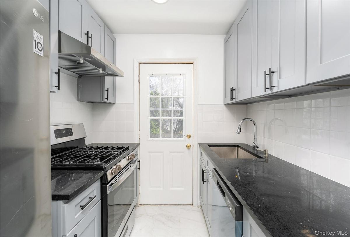 New Kitchen, SS appliances, sleek cabinetry extended height, stone counter tops, deep sink