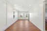 Enter into Main Level Living Room.  Laminate flooring, hi-hat lighting, and fresh paint throughout