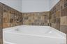 Corner Soaking Tub with Tile Surround