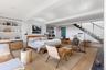 With hardwood floors, custom built-ins, gas fireplace and floating stairs to main floor