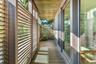 With sliding mahogoany gates to open to ocean and landscaped views