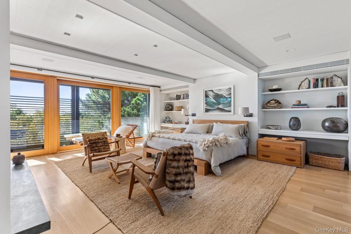 With custom built ins and oversized doors to outside mahogany deck