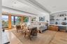 With custom built ins and oversized doors to outside mahogany deck