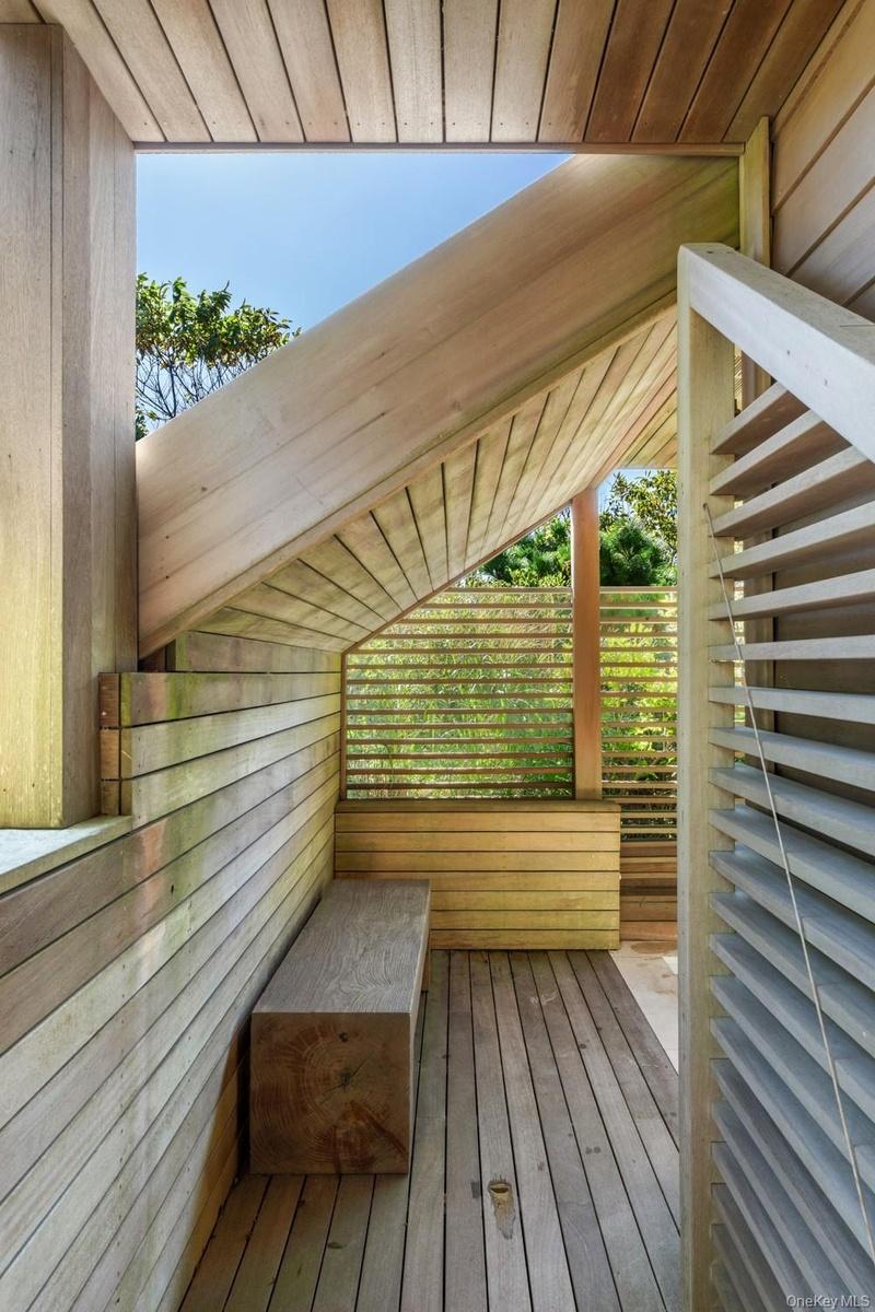 Outdoor sitting area with 2 x 4 custom mahogany slats and flooring.