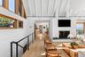With access to staircase to lower level and view of the kitchen.