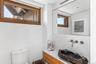 On 2nd floor with custom designed cabinetry and Dale Rogers Ammonite petrified wood sink