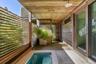 With plunge pool and 2 x 4 custom mahogany slats for privacy.
