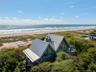 With custom made invarimate metal roof and view of the ocean.