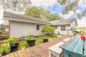 Portion of backyard fenced with deck