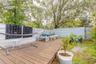 Portion of backyard fenced with deck