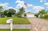 Gorgeous Curb Appeal! Mature manicured landscape, paver driveway, and Zoysia turfgrass!