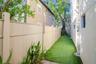 The side yard is fenced and turfed
