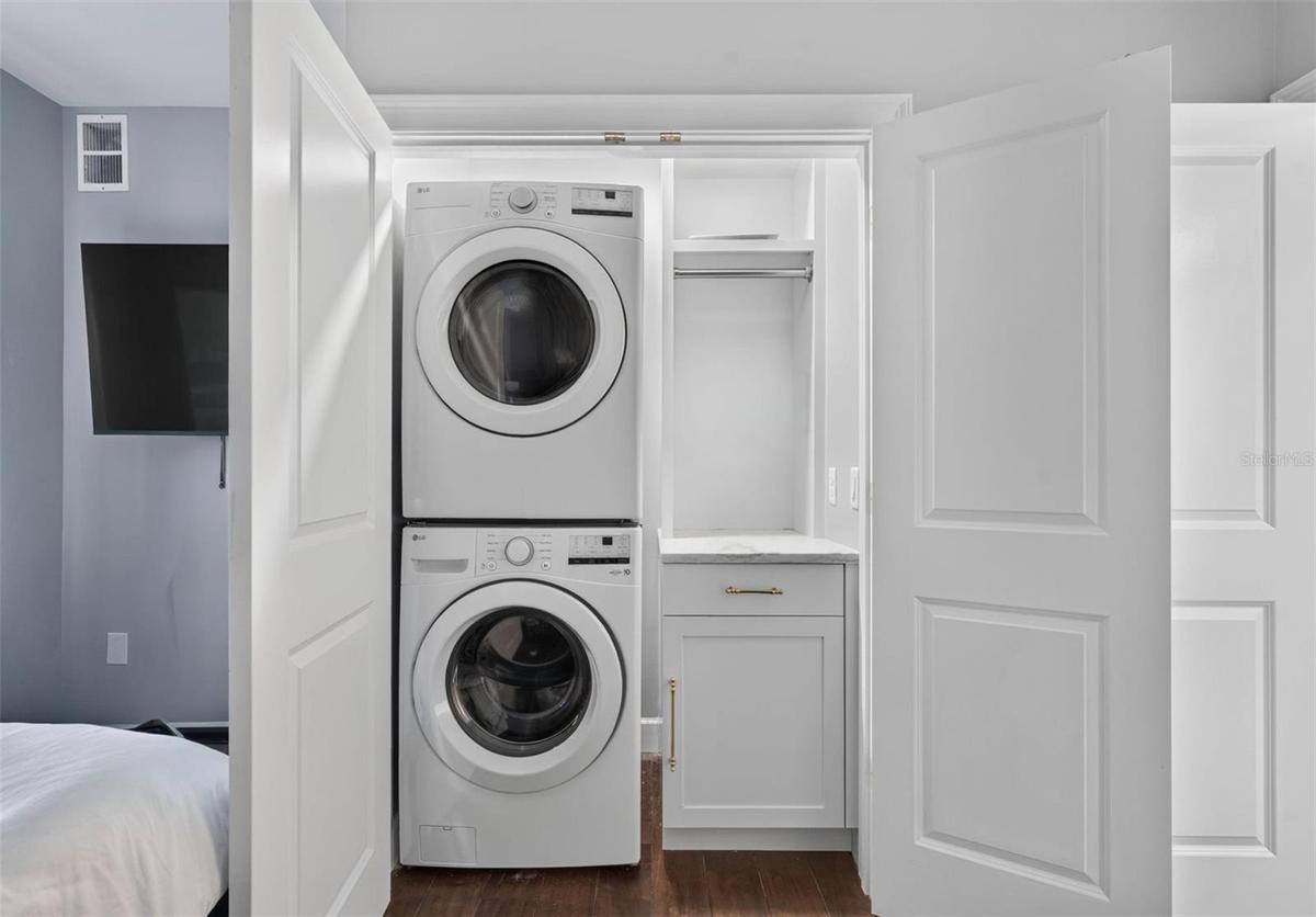 Laundry closet in secondary bedroom